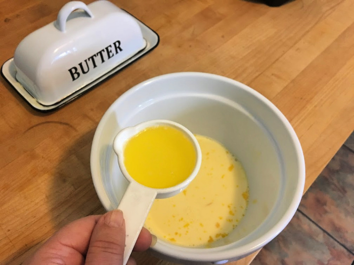 adding butter to home made waffles from scratch
