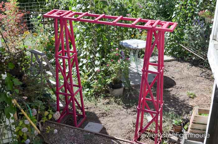 garden arbor made from obelisk and painted fuchsia 