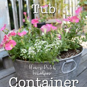 pink petunias and white alyssum in a galvanized tub planter with text overlay, Galvanized Tub Container Garden, Flower Patch Farmhouse