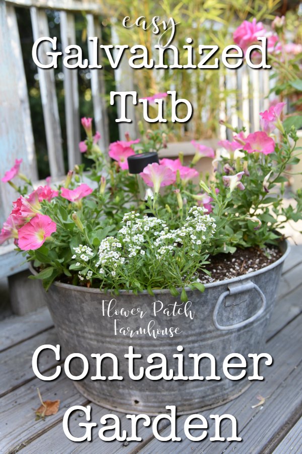 pink petunias and white alyssum in a galvanized tub planter with text overlay, Galvanized Tub Container Garden, Flower Patch Farmhouse