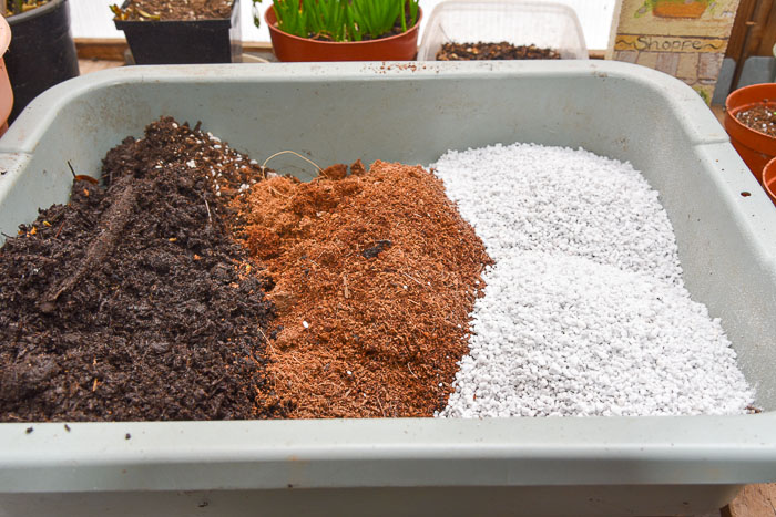 potting soil ingredients in a tub ready to be mixed
