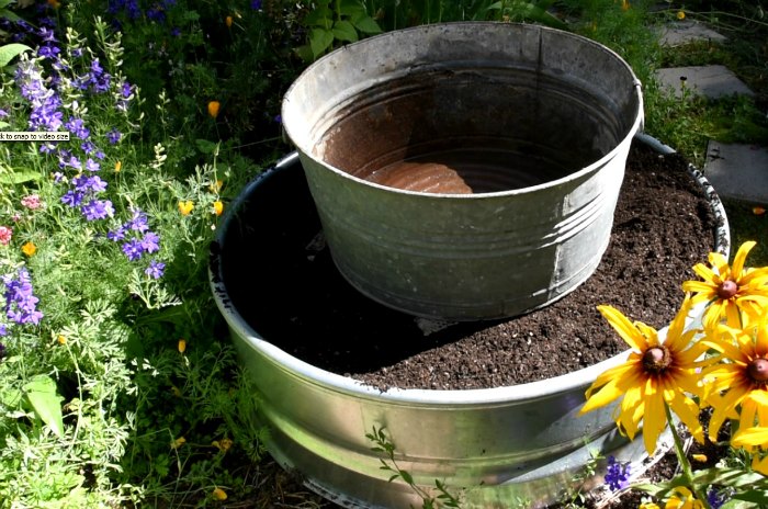 galvanized tub on top of soil filled fire ring