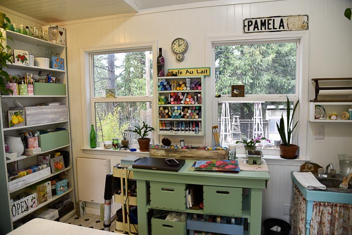 workbench and diy paint shelf in She Shed studio cottage