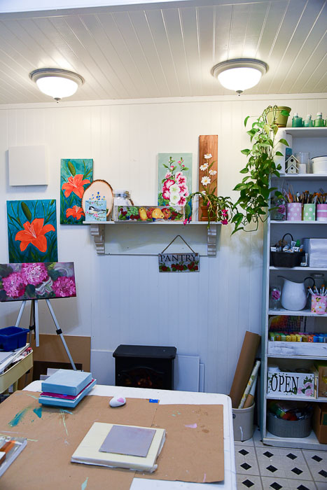 Shelf over heater holding paintings