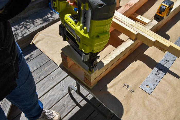 Using brad nailer to attach rung to obelisk tomato support