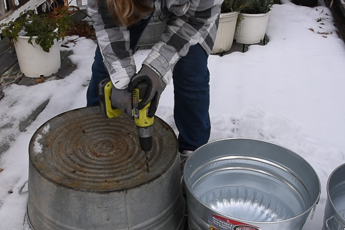 drilling holes in pots to plant bulbs in