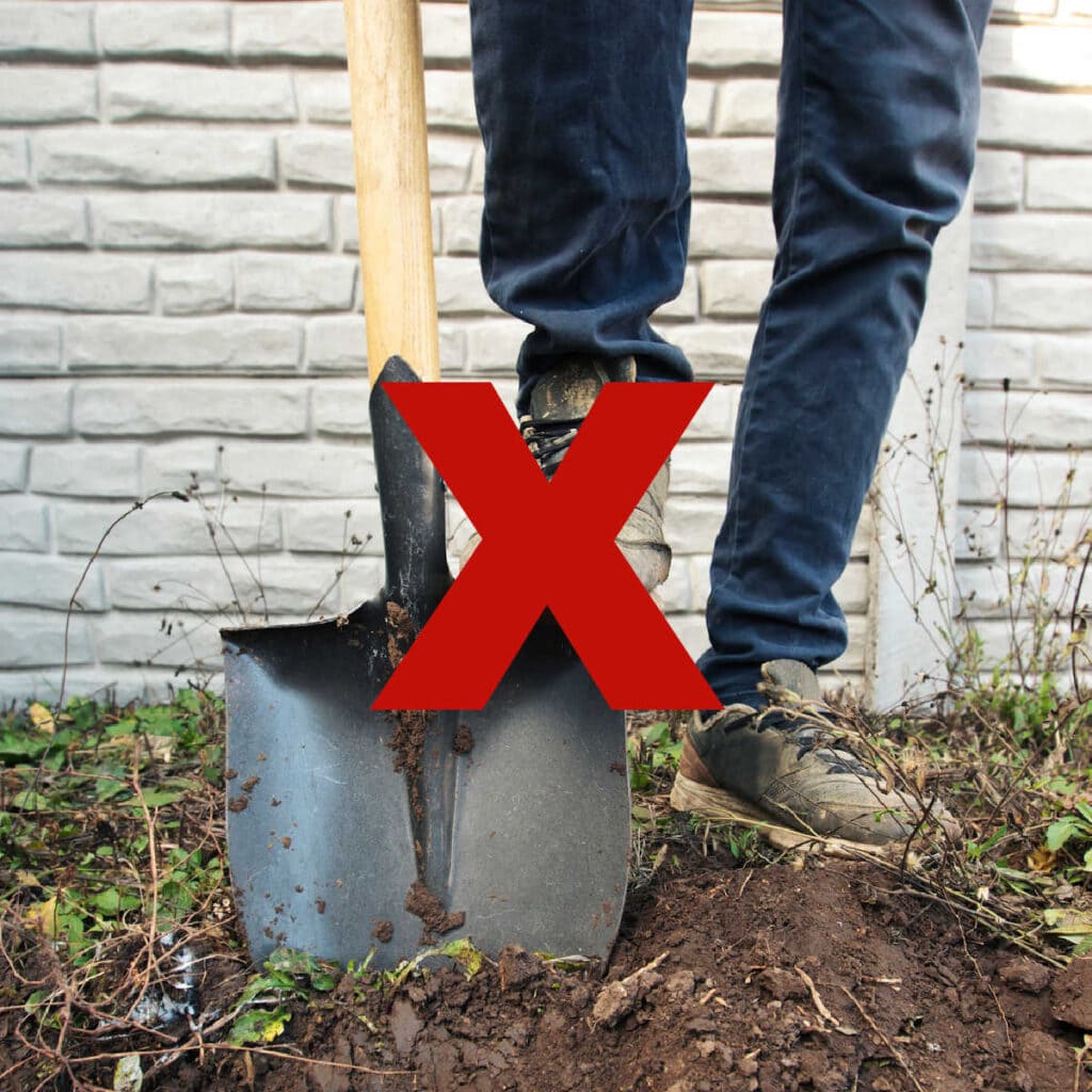 man with shovel starting to dig in soil