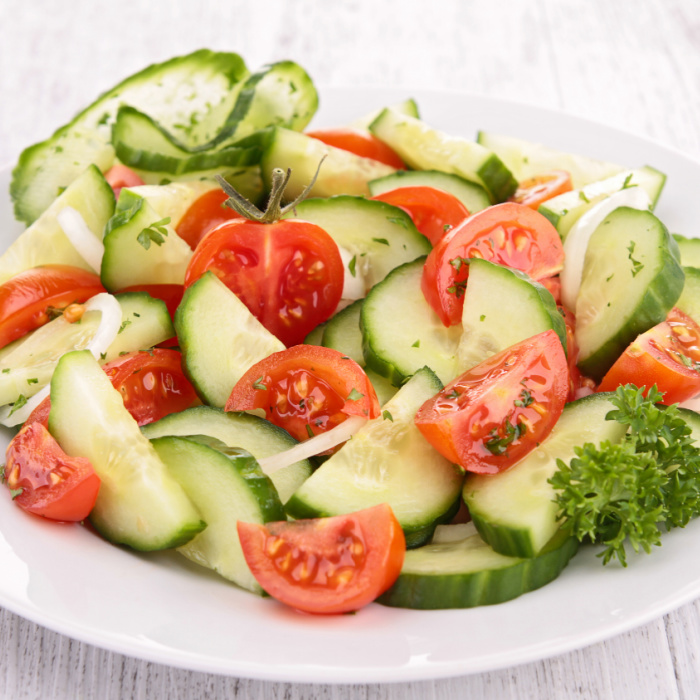tomato cucumber salad on a white plate