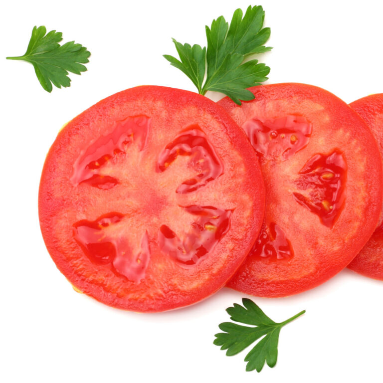 slices of an early girl tomato on white background