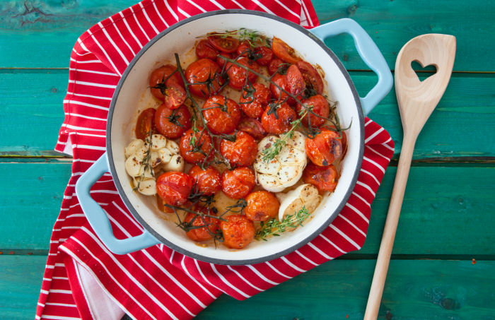 pot of roasted tomatoes with garlic and herbs