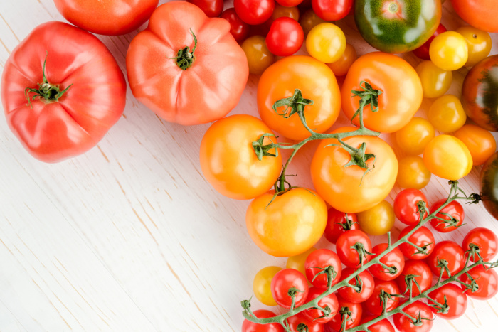 varieties of tomatoes on white background