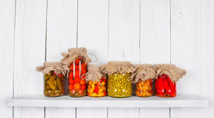 pickled peppers in jar with a white background, pepper plants