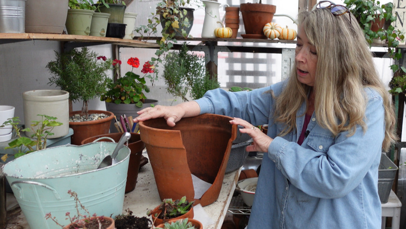 Pamela of flower patch farmhouse displaying a broken terra cotta pot readied for planting the succulent miniature garden