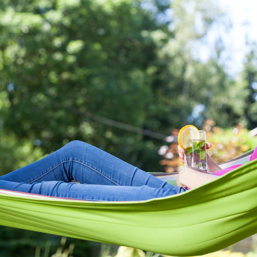 woman in hammock relaxing in the garden, 10 things I quit to make gardening easier