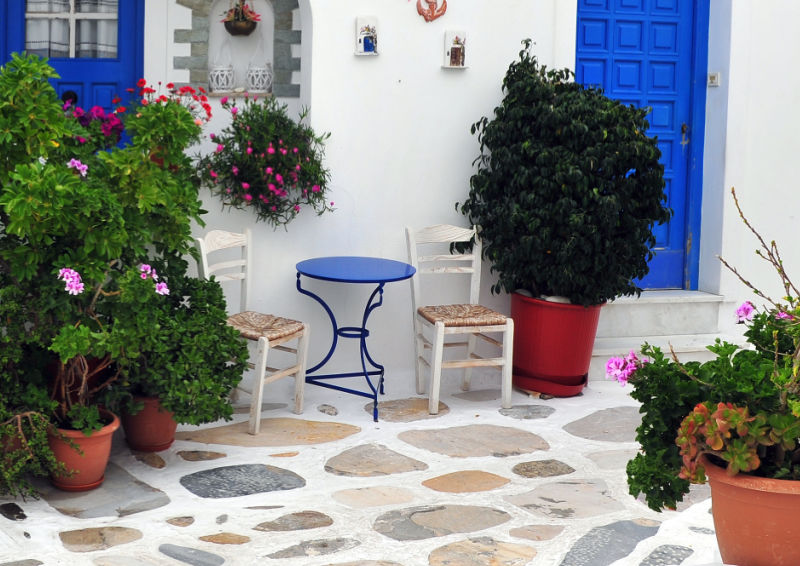 small patio seating blue table matching blue door