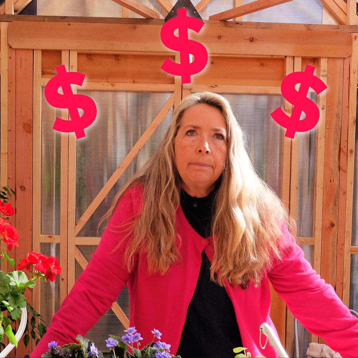 woman in bright pink sweater in a greenhouse with dollar signs arcing over her head. Blooming flowers in the foreground.